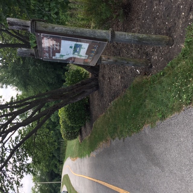Camelot connector path with trail sign
